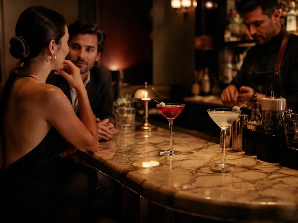 A couple having a thoughtful conversation in an elegant cocktail bar